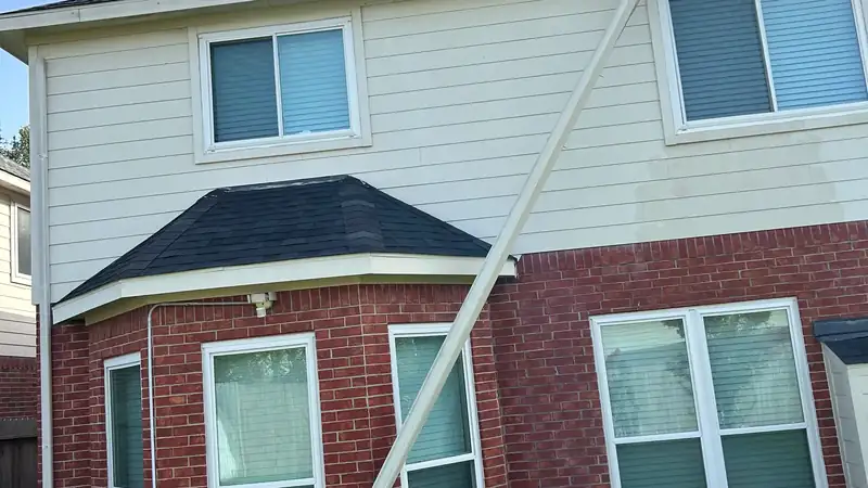 Downspout running down the side of a brick home
