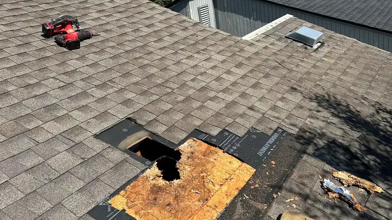 Underlayment and new decking installed on a repaired roof section