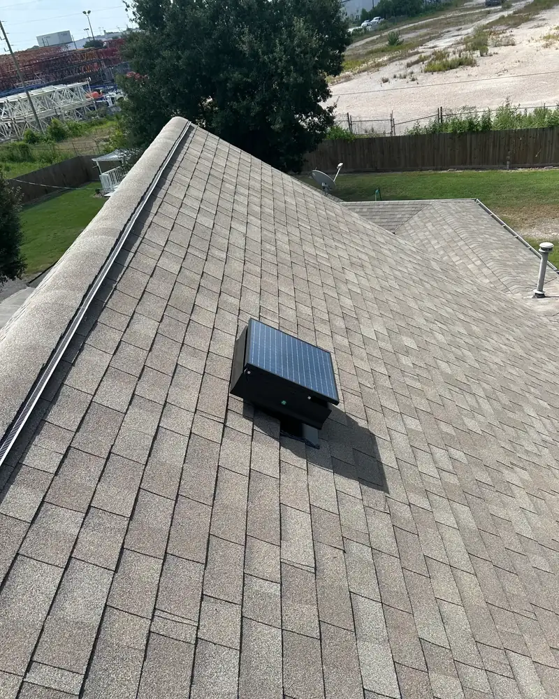 Solar attic fan installed on a residential roof, photographed on the job